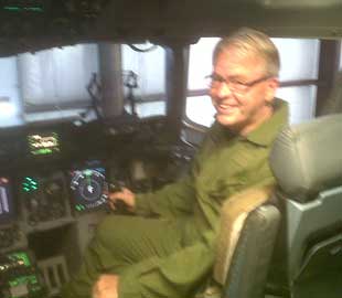 Hyer in the Cockpit of a Globemaster aircraft