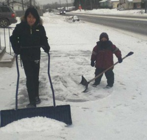 Laureen and Darius shovel the snow