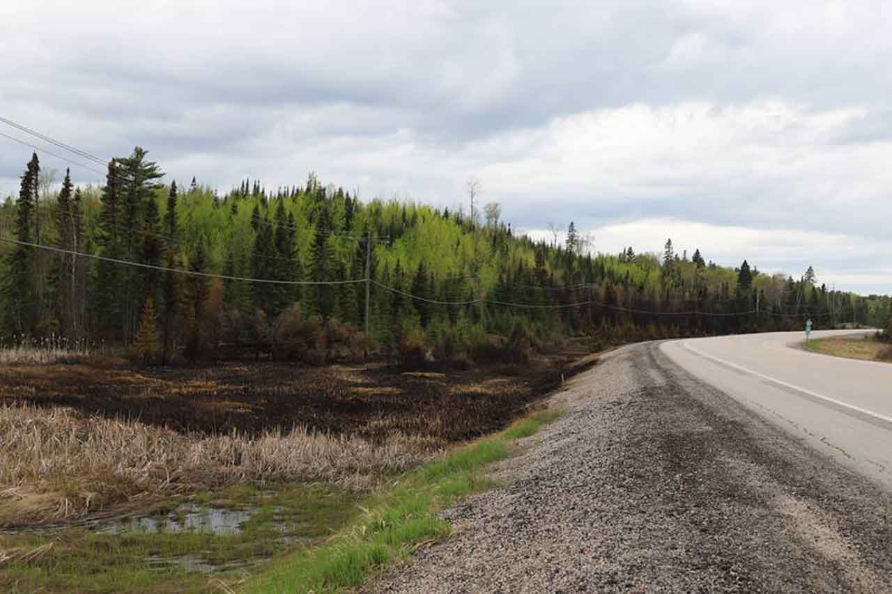 Photo Credit: Aviation, Forest Fire and Emergency Services FireRangers from the Dryden Fire Management Headquarters are seen moving forest fire suppression equipment on Dryden 5 (DRY005), May 21, 2024. The west side of Dryden 5 (DRY005) as viewed westbound on Highway 17, May 21, 2024.